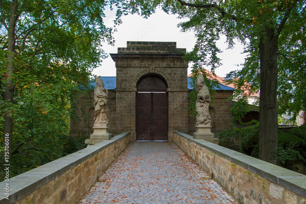 Closed castle door with statues on each side