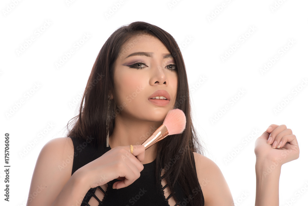 Portrait of beautiful Asian woman holding a brush near her face. Skin care Cosmetics concept. Portrait of beautiful Asian woman holding a brush near her face. Skin care Cosmetics concept.