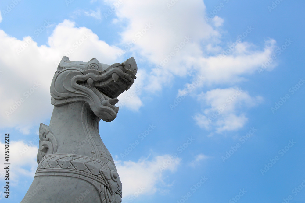White Thai dragon statue under a blue sky. White Thai dragon statue under a blue sky.