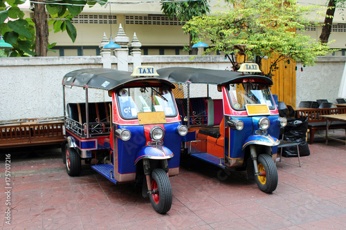 Two blue tuk tuk parked in Bangkok, Thailand.