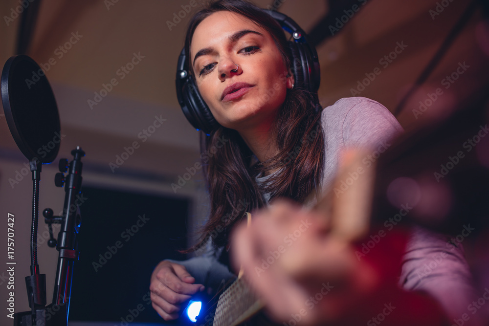 Guitarist playing guitar in a recording studio Stock Photo | Adobe Stock