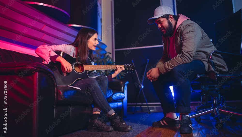Fototapeta premium Man and woman composing a song on the guitar