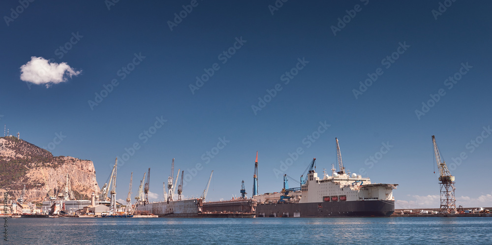 Harbor of Palermo, shipyard, harbor crane and ship, mountains in background - Sicily