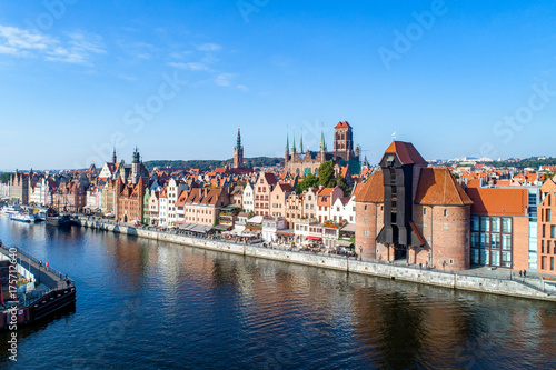 Gdansk old city in Poland with the oldest medieval port crane (Zuraw) in Europe, St Mary church, Town hall tower and Motlawa River. Aerial view, early morning.
