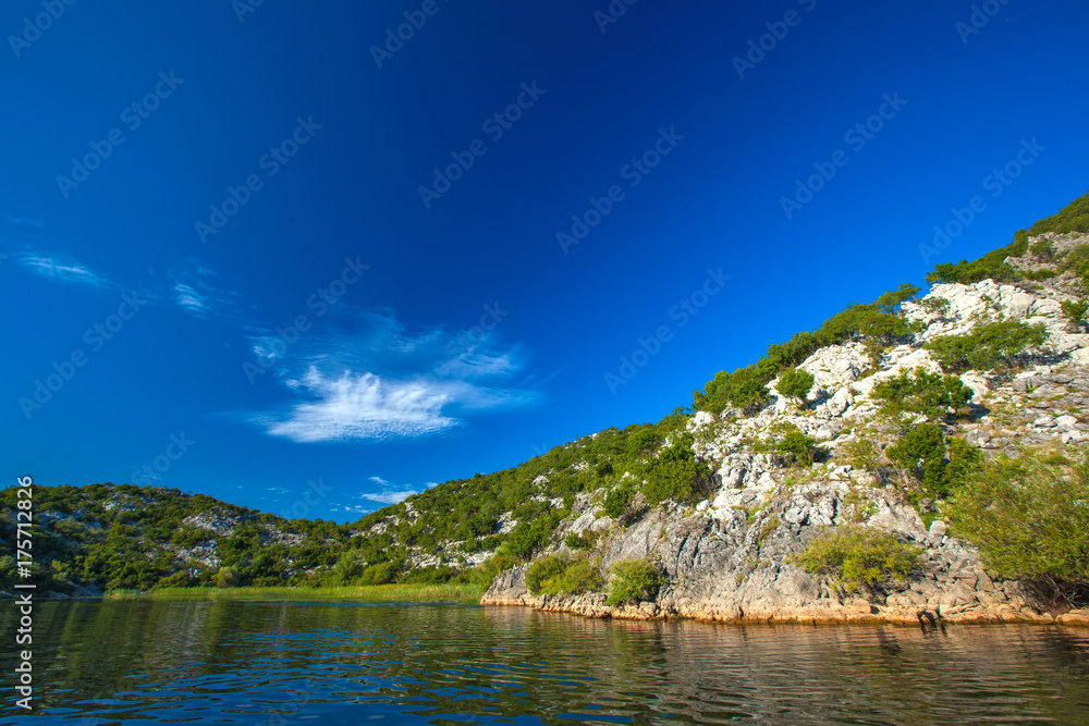 Slope of a rocky mountain with trees on the Skadar Lake. Montenegro.