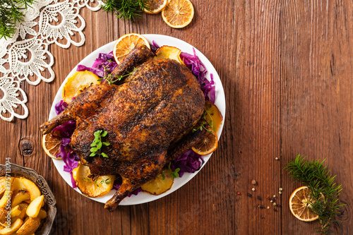 Baked whole duck, served with apples, red cabbage, oranges and roasted fritters.
