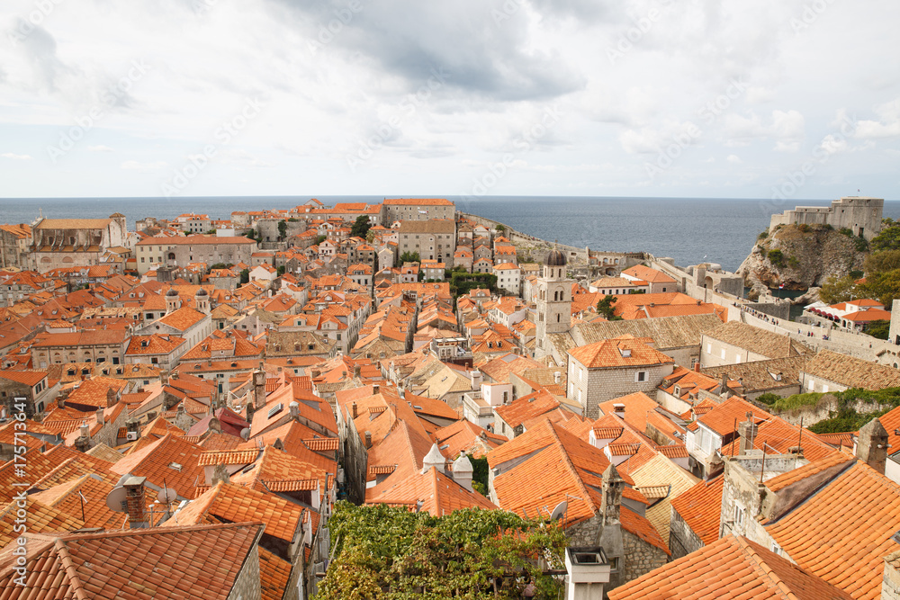 view from above of the tiled roofs of houses and Fort Lovrijenac. Dubrovnik, Croatia