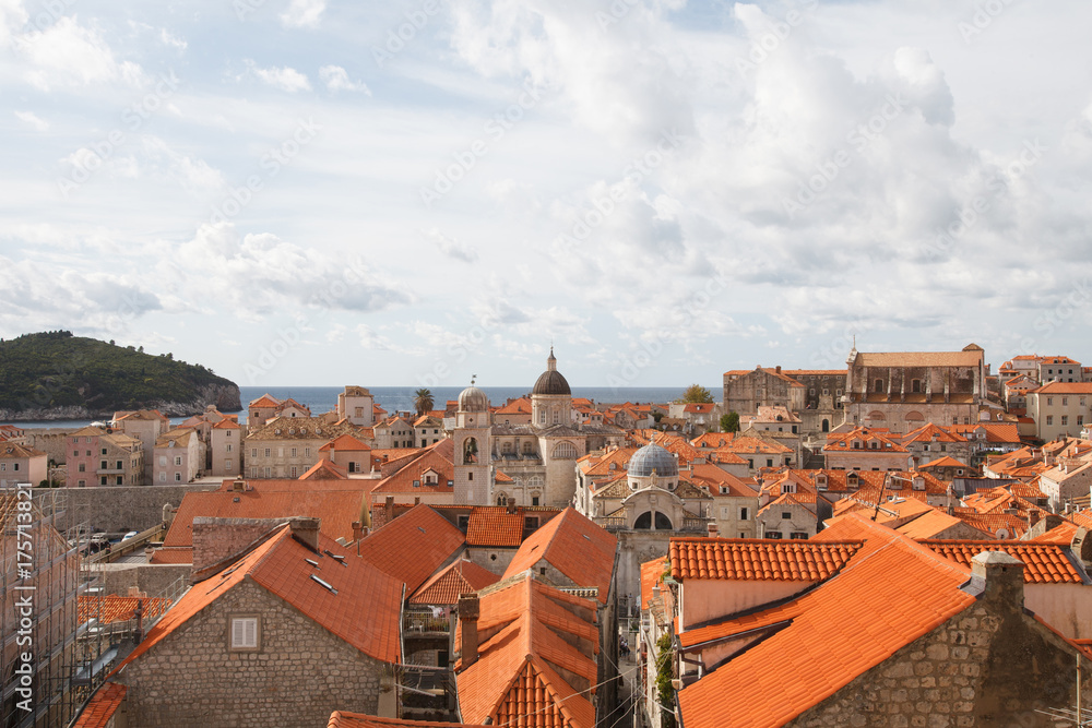 Panorama of the old city of Dubrovnik. A view of the red roofs of the houses and the cathedral.