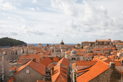 Panorama of the old city of Dubrovnik. A view of the red roofs of the houses and the cathedral.