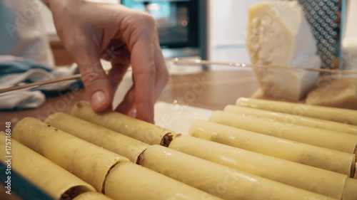 Woman cooking cannelloni Italian pasta at home, part of the set