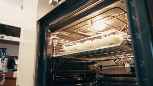 Wallpaper Mural Woman cooking cannelloni Italian pasta at home, part of the set. Putting pan into an oven Torontodigital.ca