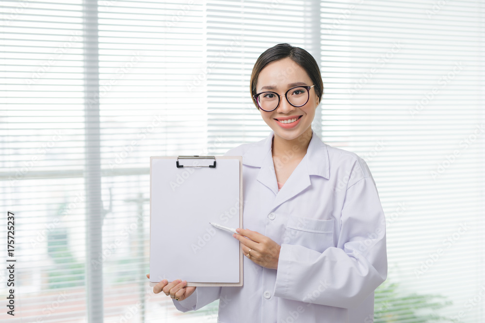 Asian woman doctor standing with folder at hospital Asian woman doctor standing with folder at hospital