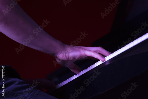 hand of a man playing the piano