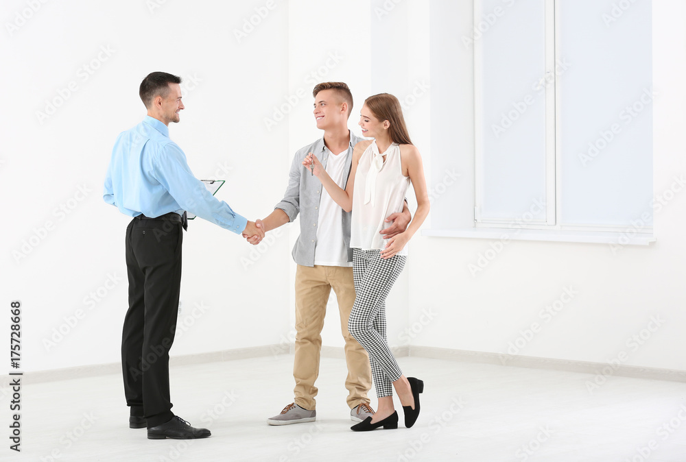 Man shaking hands with estate agent in new apartment Man shaking hands with estate agent in new apartment