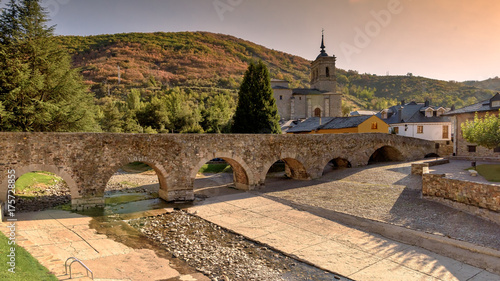 Dry river bed under Roman bridge during drought in Molinaseca, Spain. photo