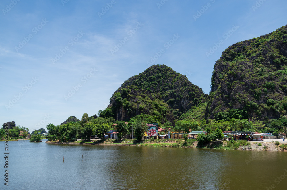 Soaring limestone cliffs in Inland Haolong Bay, Ninh Binh, Vietnam.