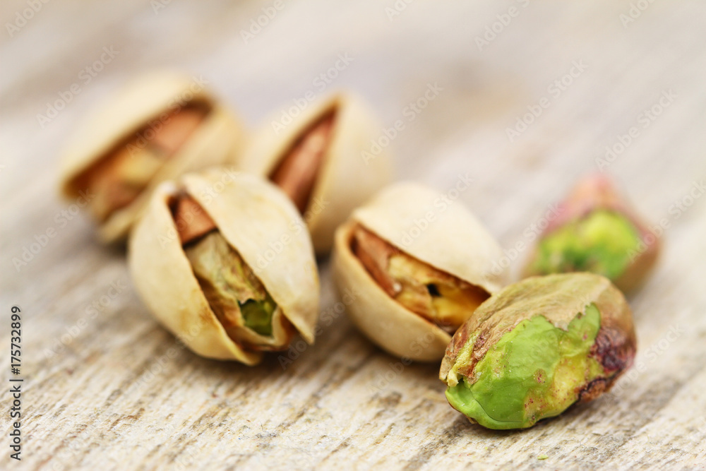 Close up of few pistachio nuts on rustic wooden surface
Close up of few pistachio nuts on rustic wooden surface
