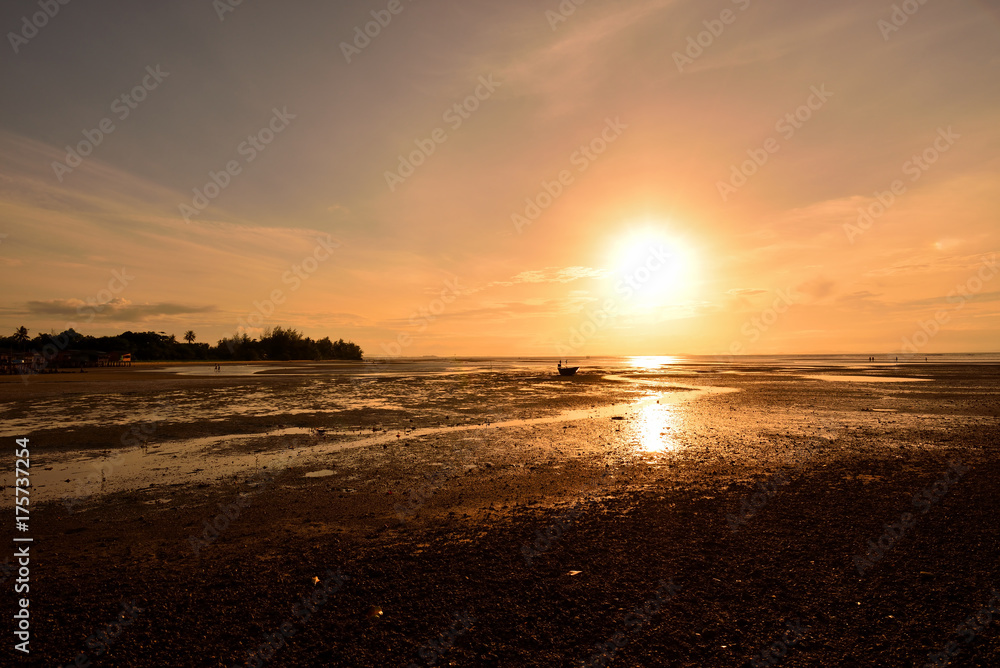 The sun shines on the horizon and reflects down on the water surface The sun shines on the horizon and reflects down on the water surface