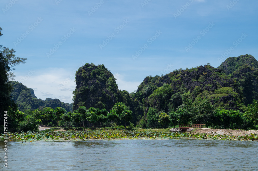 Rowboats transporting tourists in Inland Haolong Bay, Ninh Binh, Vietnam. Rowboats transporting tourists in Inland Haolong Bay, Ninh Binh, Vietnam.