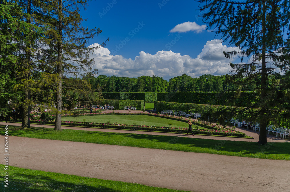 Fototapeta premium A horizontal road in a European garden. Summer vacation in the park.