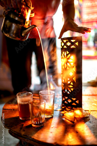 Pouring tea in glass in traditional oriental style