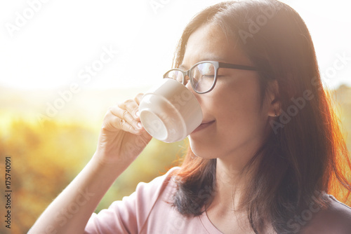 Woman drinking hot coffee.