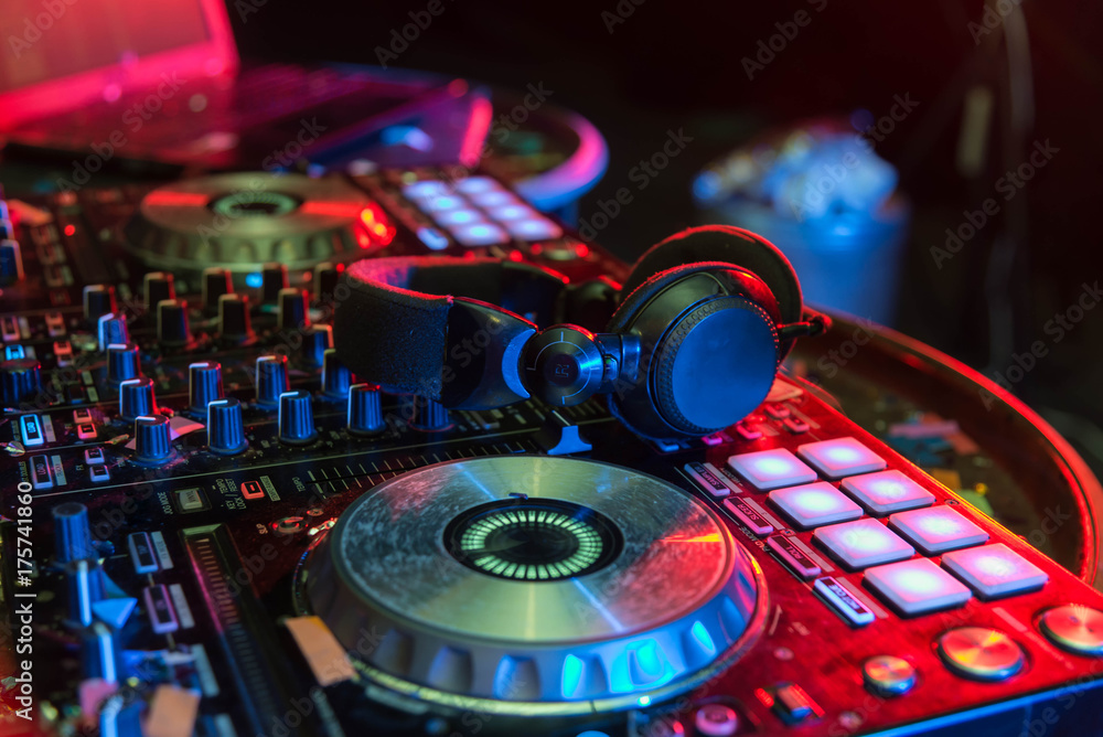 DJ sound equipment at nightclubs and music festivals, EDM, . Party concept,  sound technique. DJ playing on the best, famous CD players. Dj mixer with  headphones at nightclub bokeh background. Stock Photo |