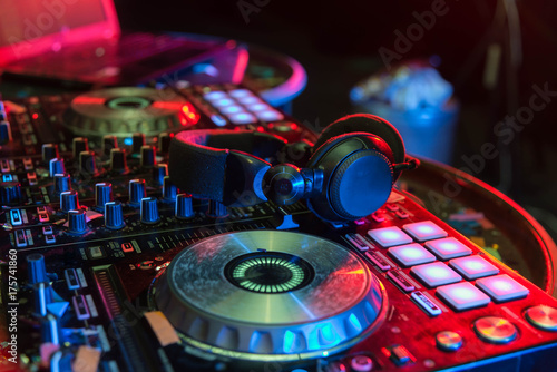 DJ sound equipment at nightclubs and music festivals, EDM, . Party concept, sound technique. DJ playing on the best, famous CD players. Dj mixer with headphones at nightclub bokeh background.