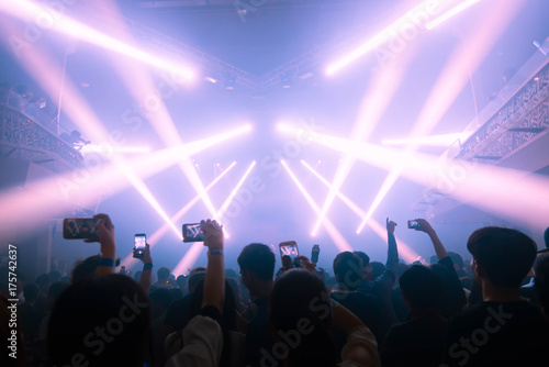Concert and celebration party new year ,Young people record with smart phone. Celebrate new year party , Blurry night club party people enjoy .Rock concert new year party.