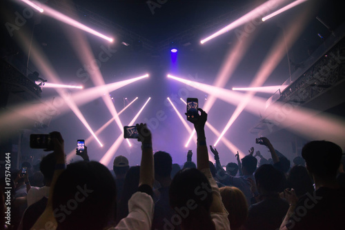 Concert and celebration party new year  Young people record with smart phone. Celebrate new year party   Blurry night club party people enjoy .Rock concert new year party.