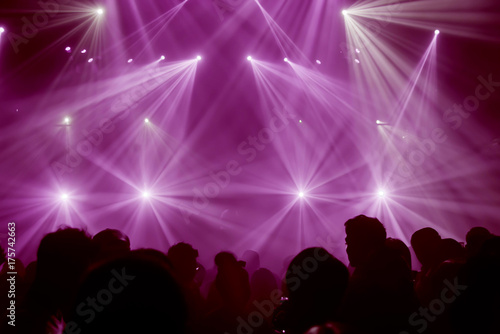 Light Show and Silhouette audience crowd people club party with concert. Celebrate new year party , Blurry night club party people enjoy .Rock co .Abstract blur for background