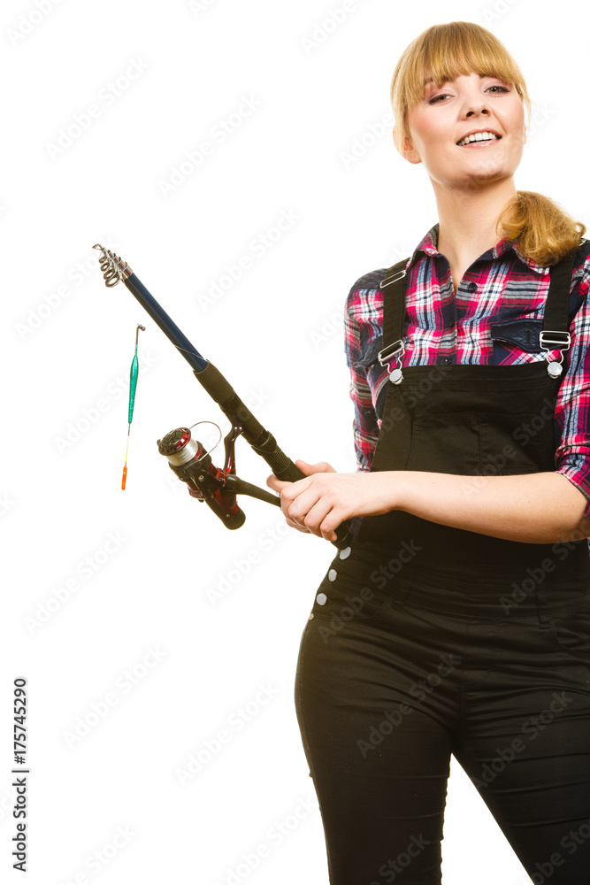 Similing woman wearing check shirt holding fishing rod Similing woman wearing check shirt holding fishing rod