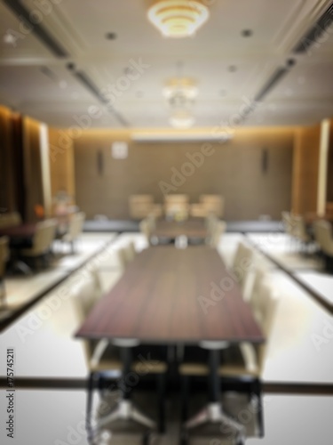 Blurred image of empty interior of conference room, meeting room prepare for webinar. Blurry nobody in Classroom, Office with chairs and tables. vintage tone. Abstract blur for background usage.