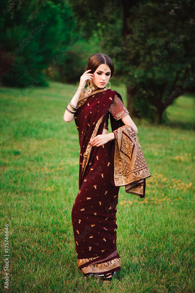 Beautiful Arabian woman portrait. Young Hindu woman with mehndi tattoos from black henna on her hands. Beautiful Arabian woman portrait. Young Hindu woman with mehndi tattoos from black henna on her hands.