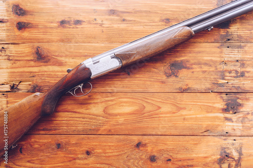 Obraz na plátně Hunting rifle isolated on wooden background