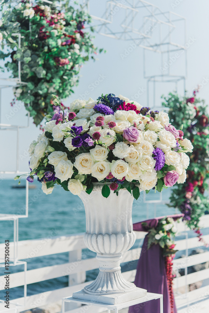festive wedding ceremony on a background a sea. Registration of holiday is in violet and blue colors