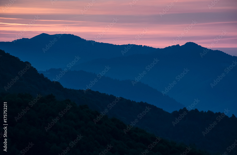 spectacular landscape with reddish sky at dawn in mountains