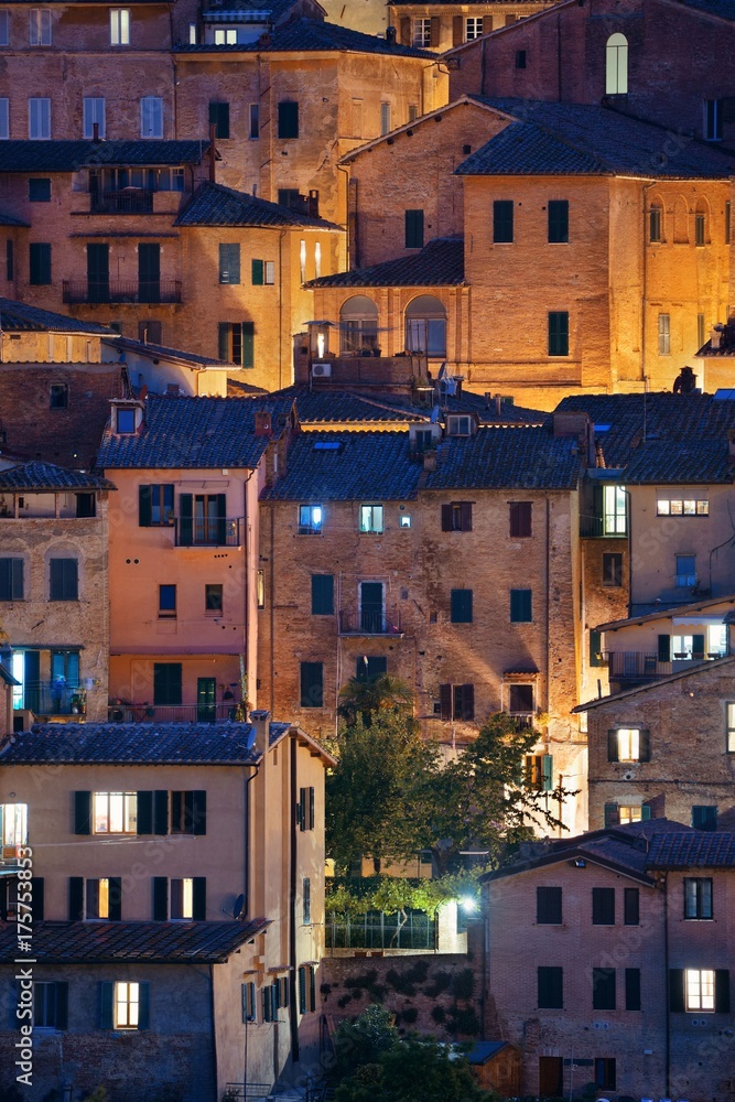 Old building background at night Siena Italy