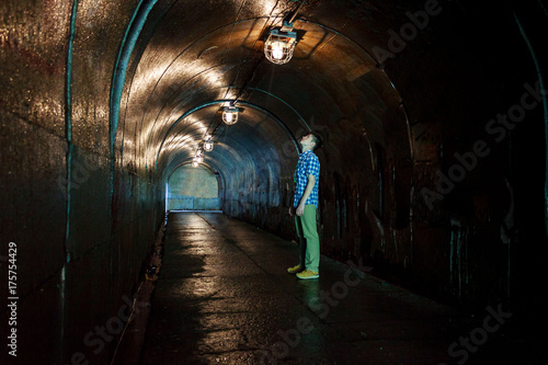 The young man looks at the tunnel arch