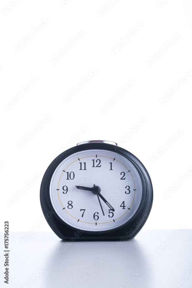 Isolated clock on table. Isolated clock on table.