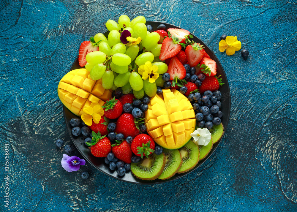 Colorful Mixed Fruit platter with Mango, Strawberry, Blueberry, Kiwi and Green Grape. Healthy food