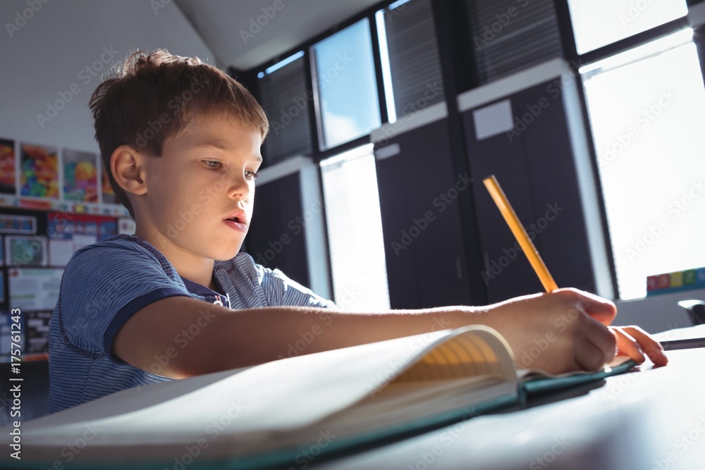 Boy writing on book Boy writing on book