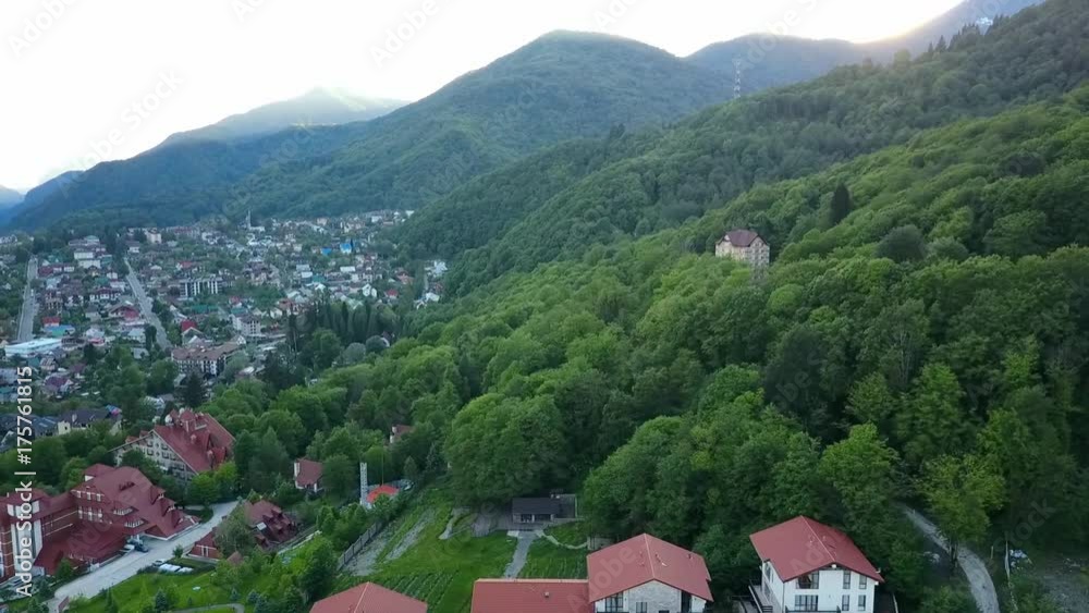 Rise above the mountain village Krasnaya Polyana in the valley sunset Rise above the mountain village Krasnaya Polyana in the valley sunset