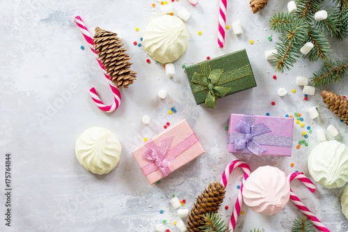 Christmas background with a present and festive decorations on a stone background. Top view. photo