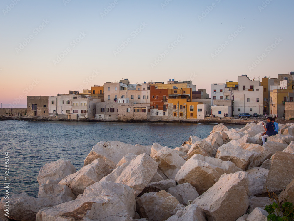 Trapani seaside colored houses in the sunset light