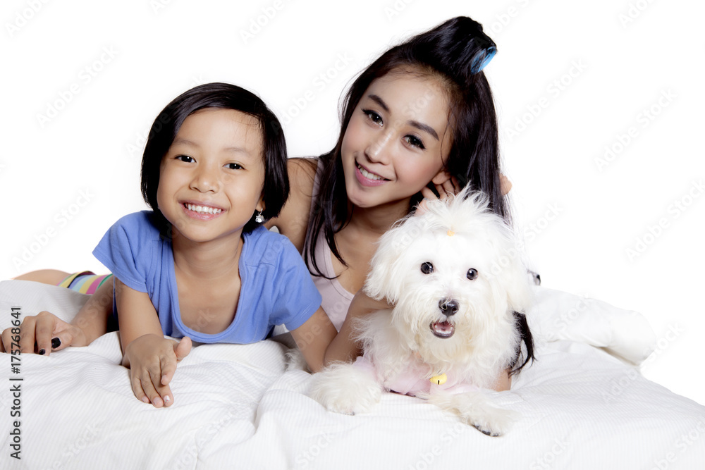 Mother and child play with dog on studio Mother and child play with dog on studio