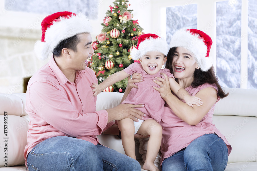 Happy family playing together on the couch Happy family playing together on the couch