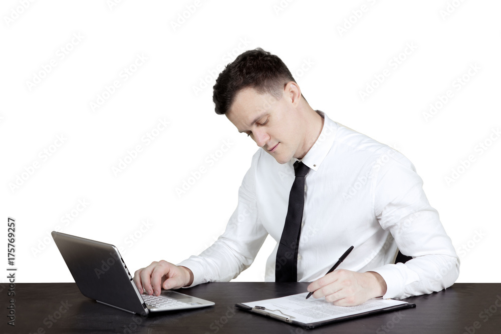 Handsome businessman writing on clipboard Handsome businessman writing on clipboard