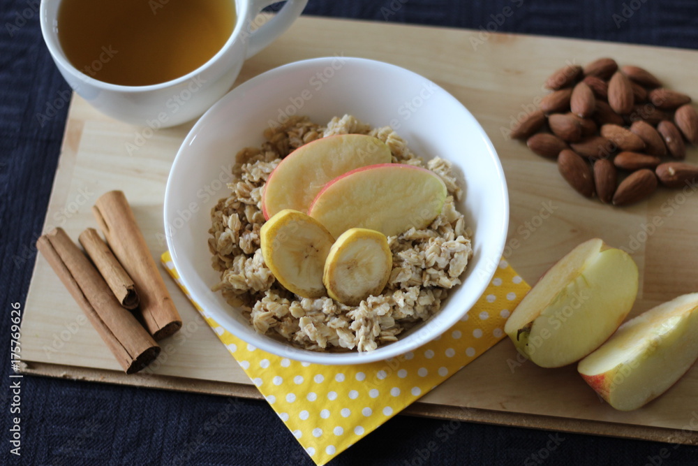 Porridge with banana, apple, cinnamon and almonds as a healthy breakfast
