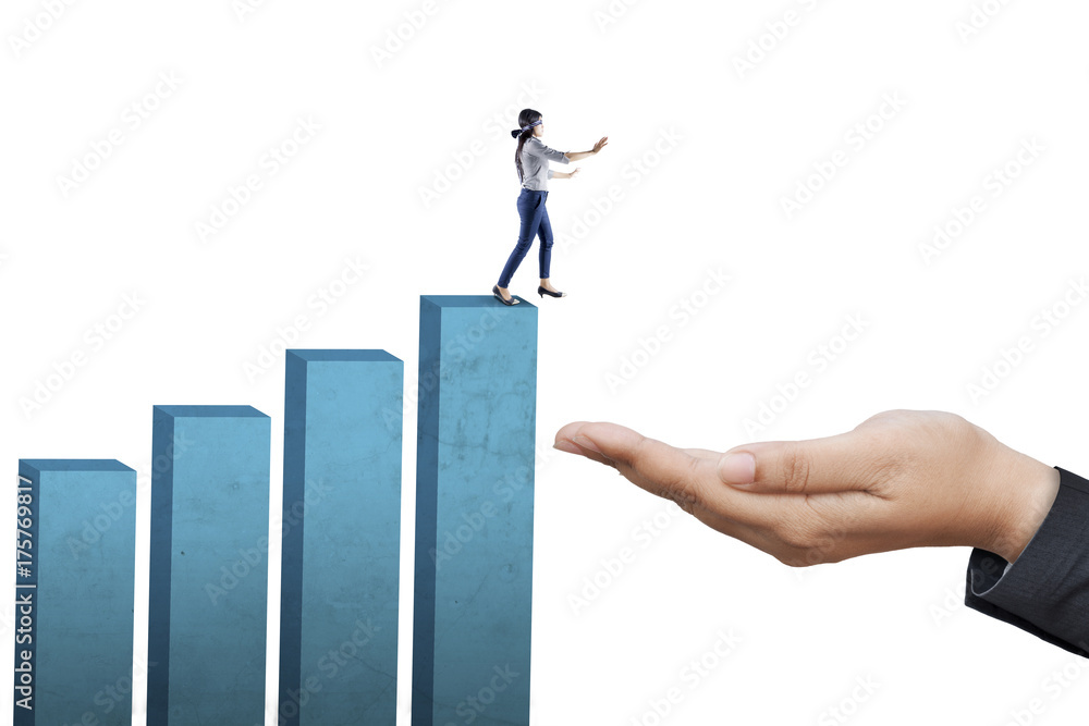 Businesswoman walking blindfolded on graph Businesswoman walking blindfolded on graph